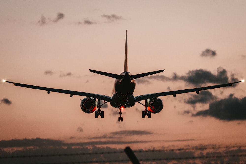 black airplane in mid air during daytime