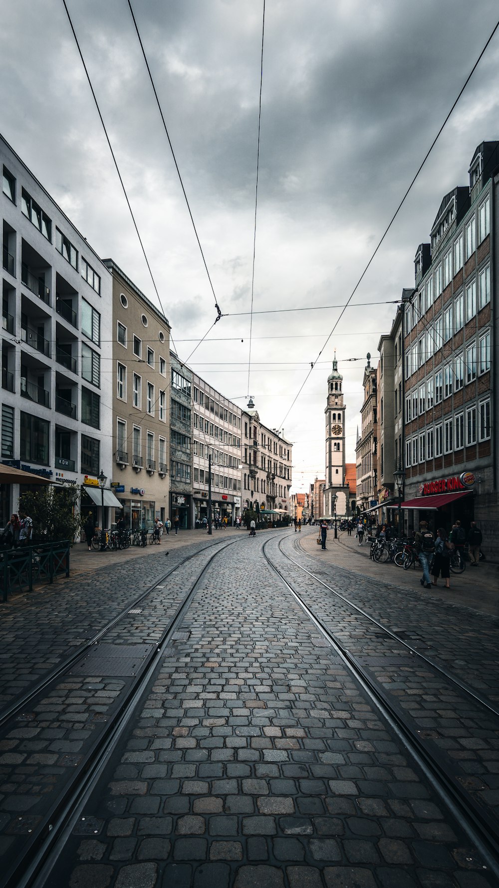 people walking on sidewalk near buildings during daytime