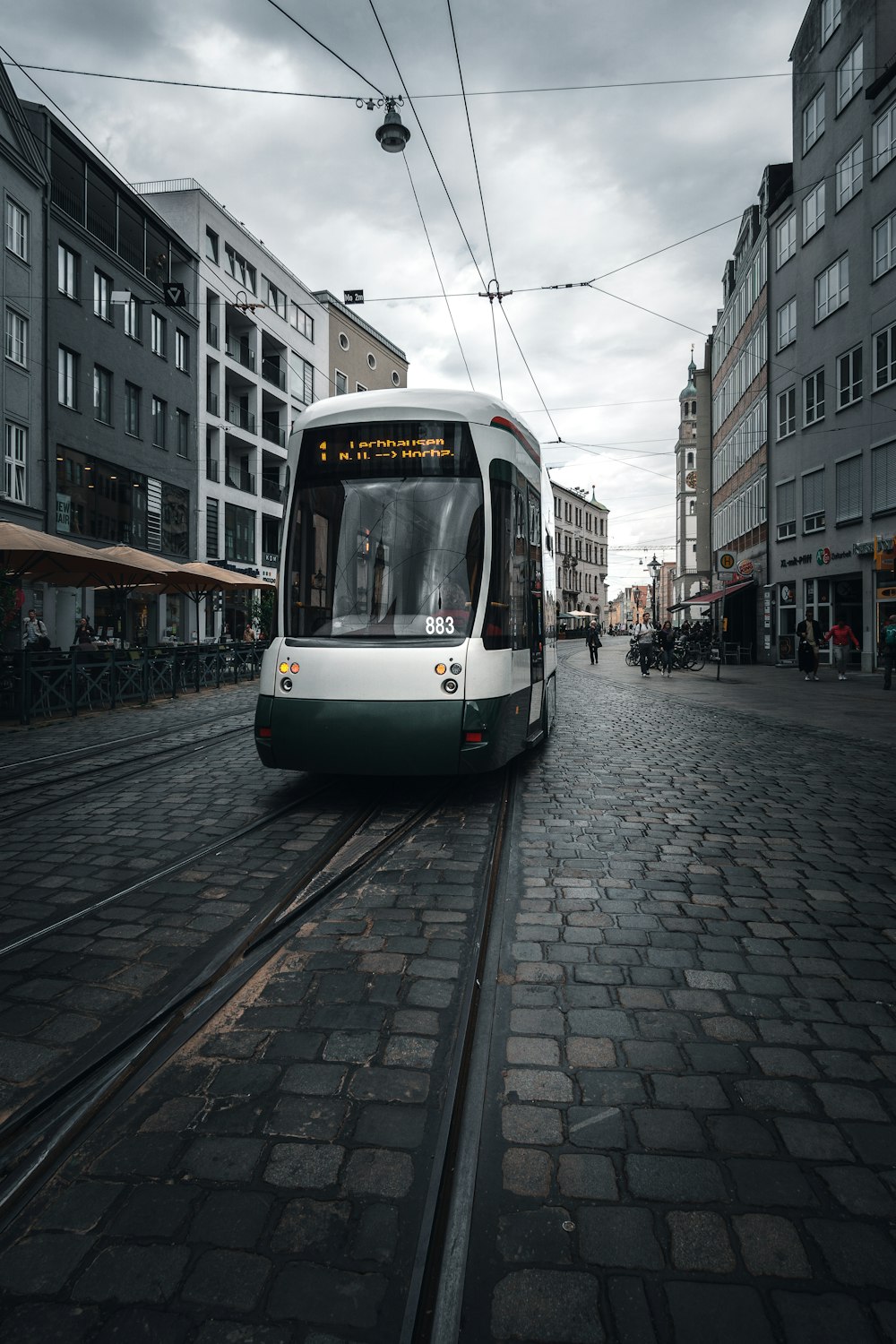 white and green tram on road during daytime