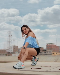 A model stretching effortlessly in a sleek, modern activewear set on a sunny city rooftop.