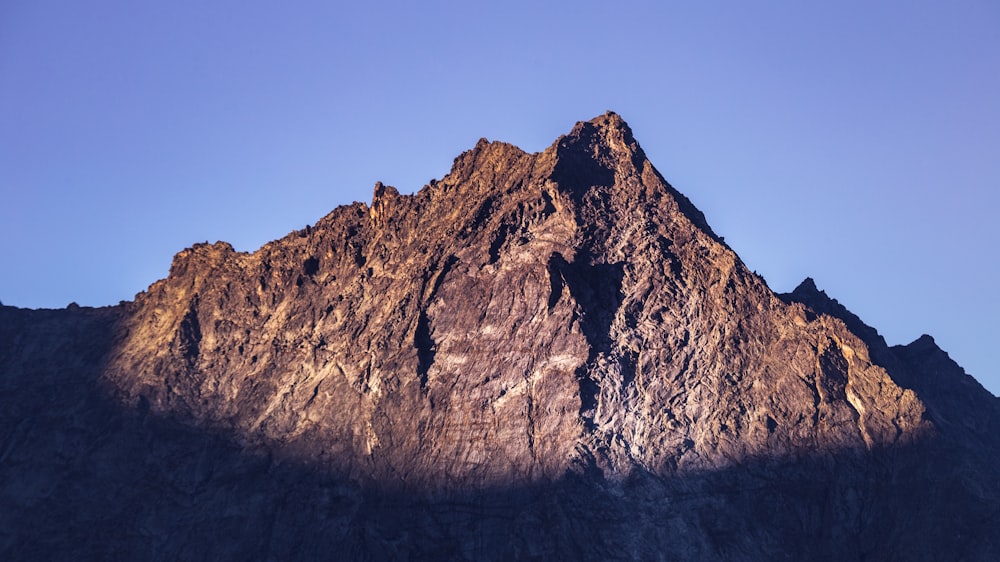 brown rocky mountain under blue sky during daytime