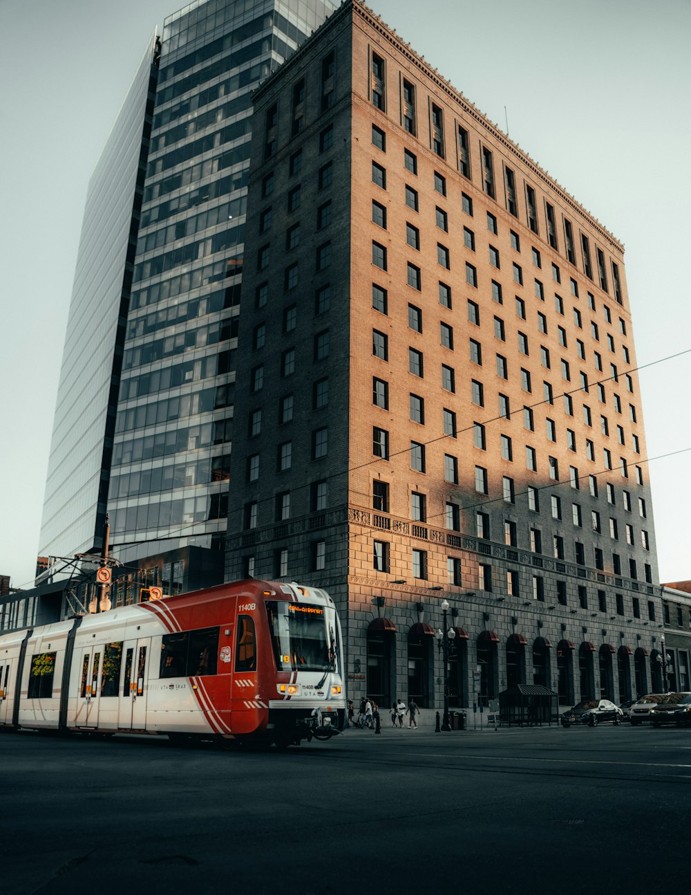 red and white bus on road near high rise building during daytime