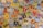 A collection of assorted Pokémon trading cards spread out, displaying various Pokémon characters, energies, and abilities. The cards vary in type, color, and design, showcasing different Pokémon species, stats, and features.