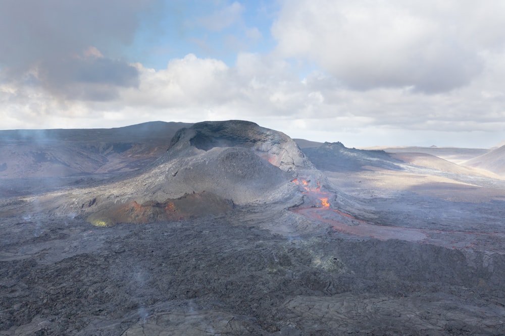 brown and black mountain under white clouds during daytime