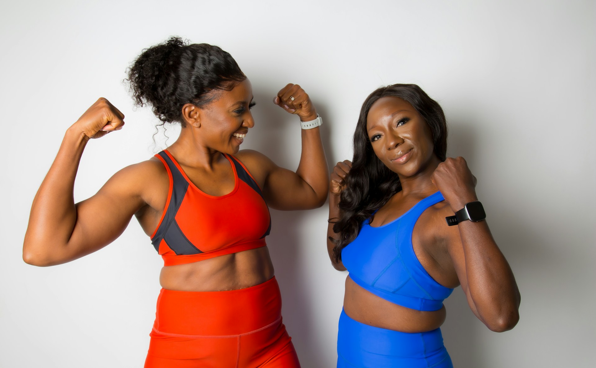 woman in blue sports bra beside woman in blue sports bra