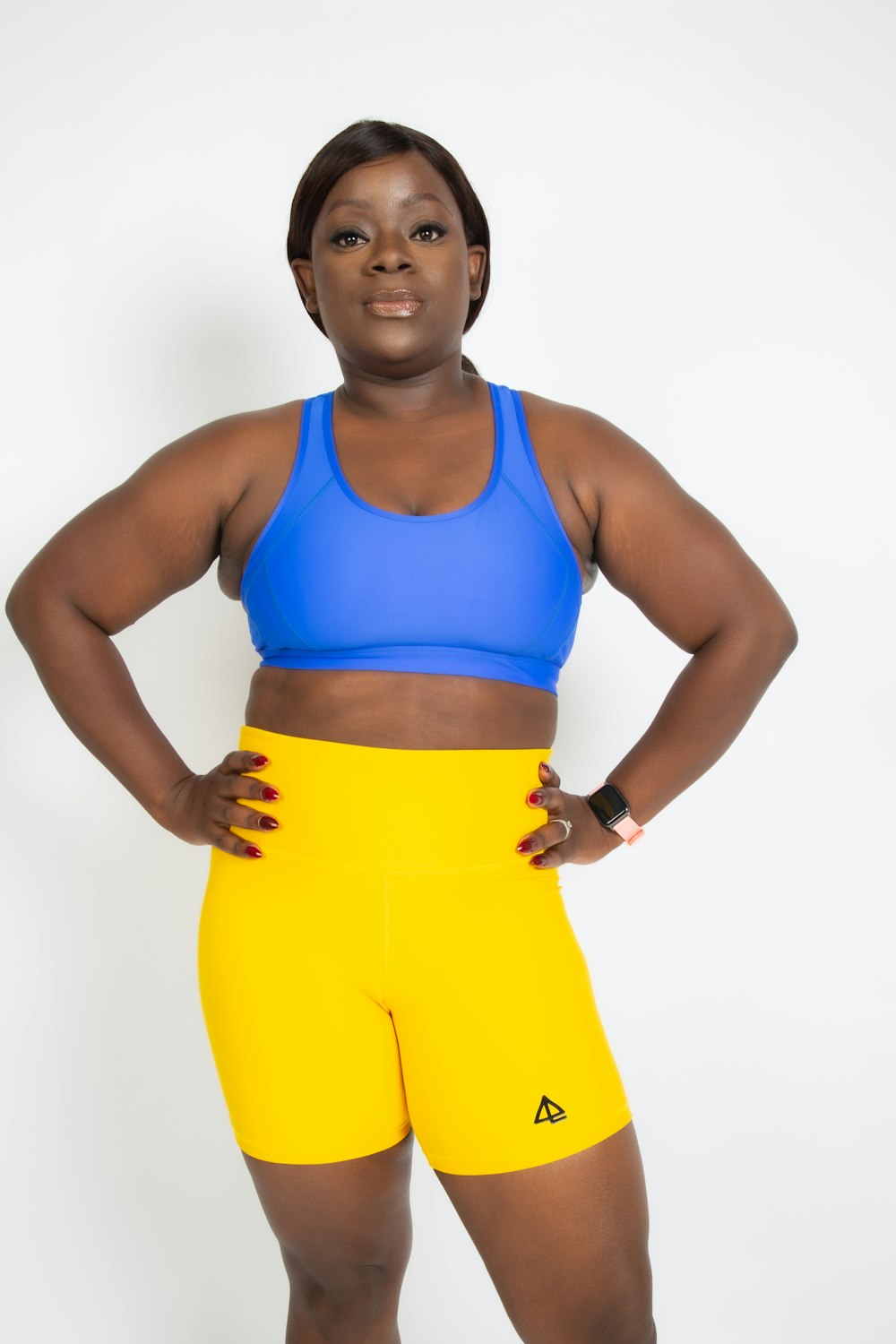 woman in blue sports bra and yellow pants