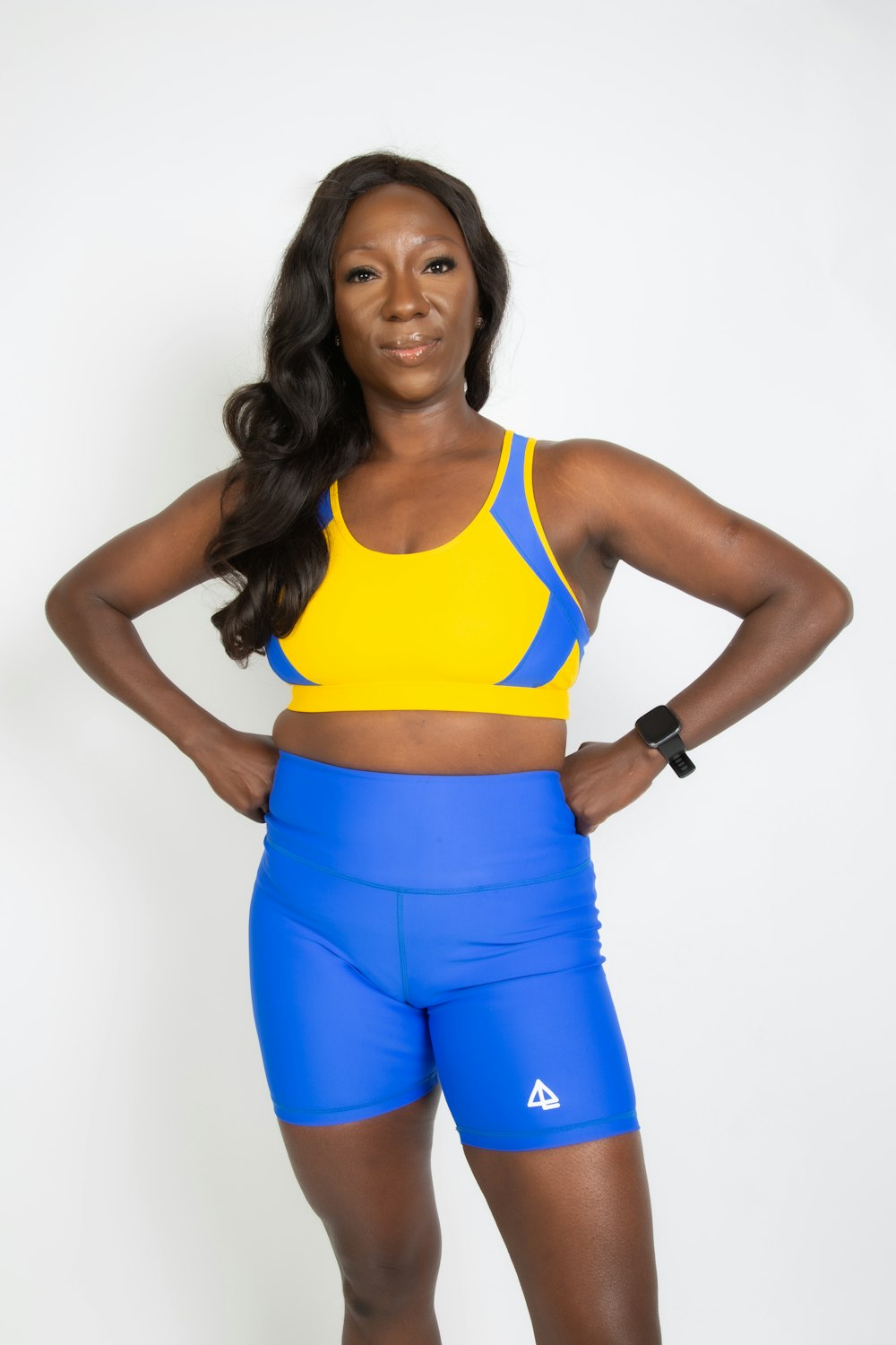 woman in yellow sports bra and blue shorts