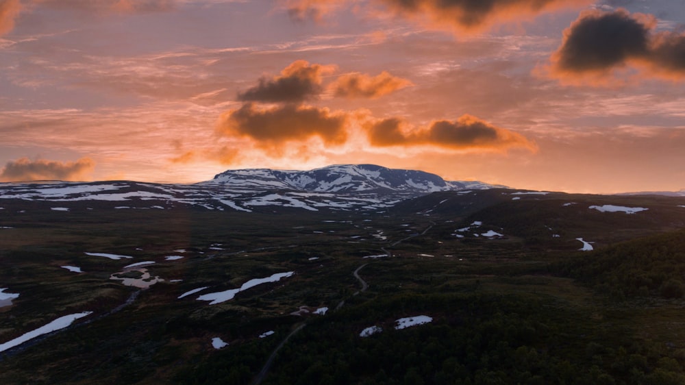 snow covered mountain under cloudy sky during daytime