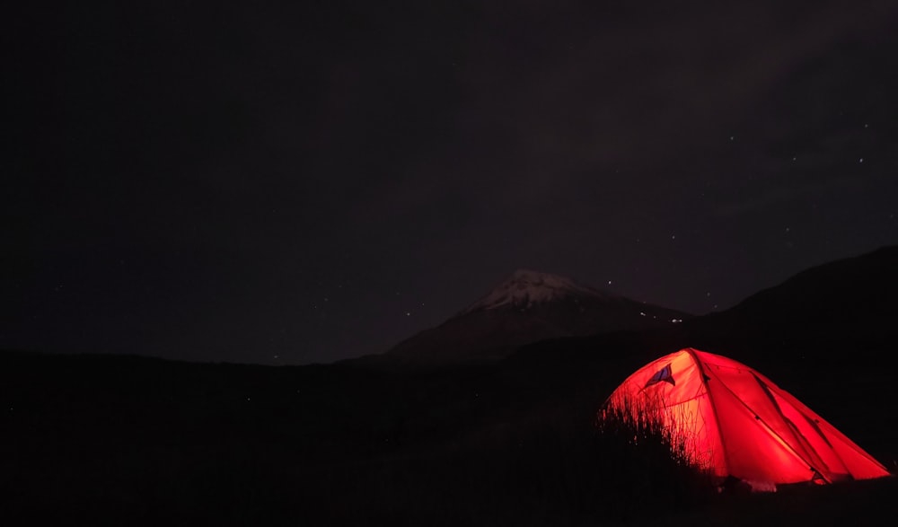 red tent on brown field during night time