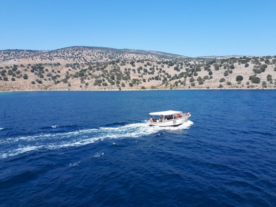 white and red boat on sea during daytime in Saranda Albania