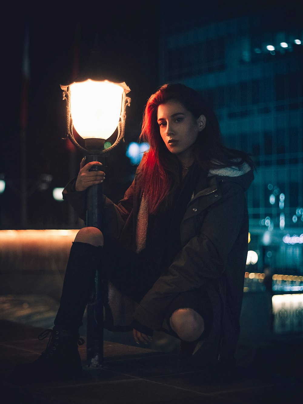 woman in black jacket holding lantern