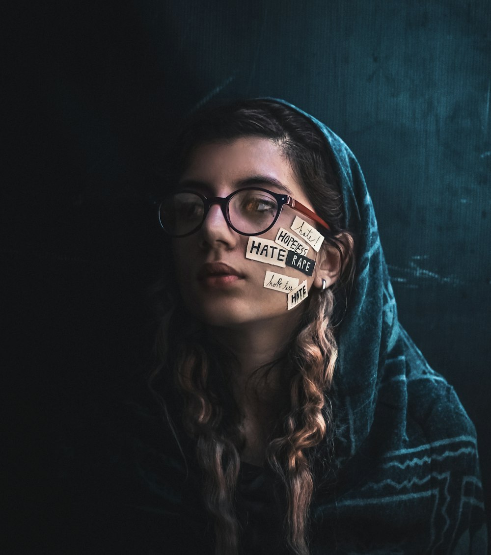 woman in black framed eyeglasses and red hoodie