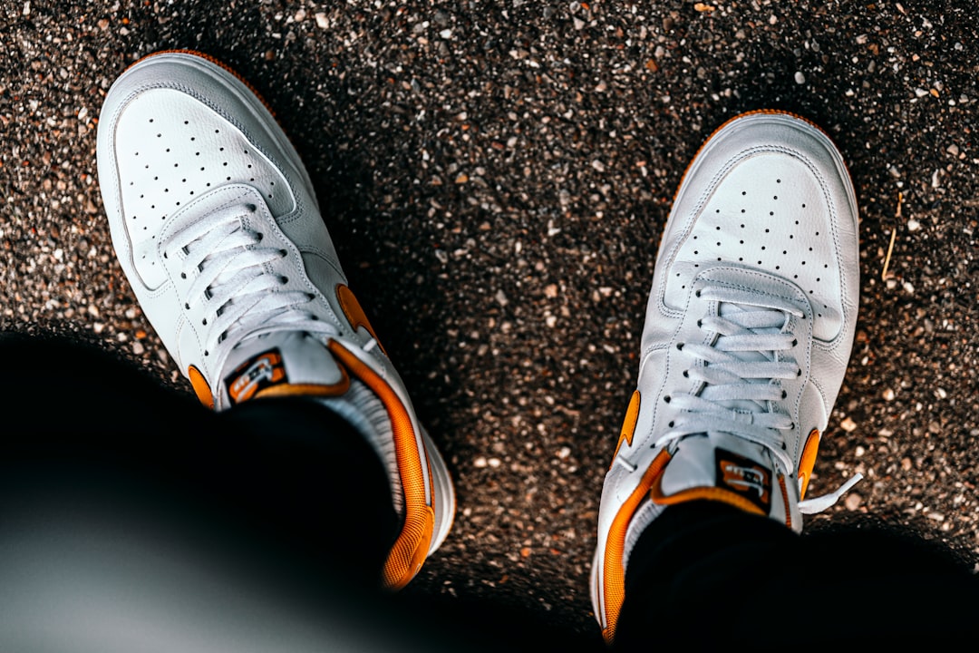 gray and orange nike athletic shoes