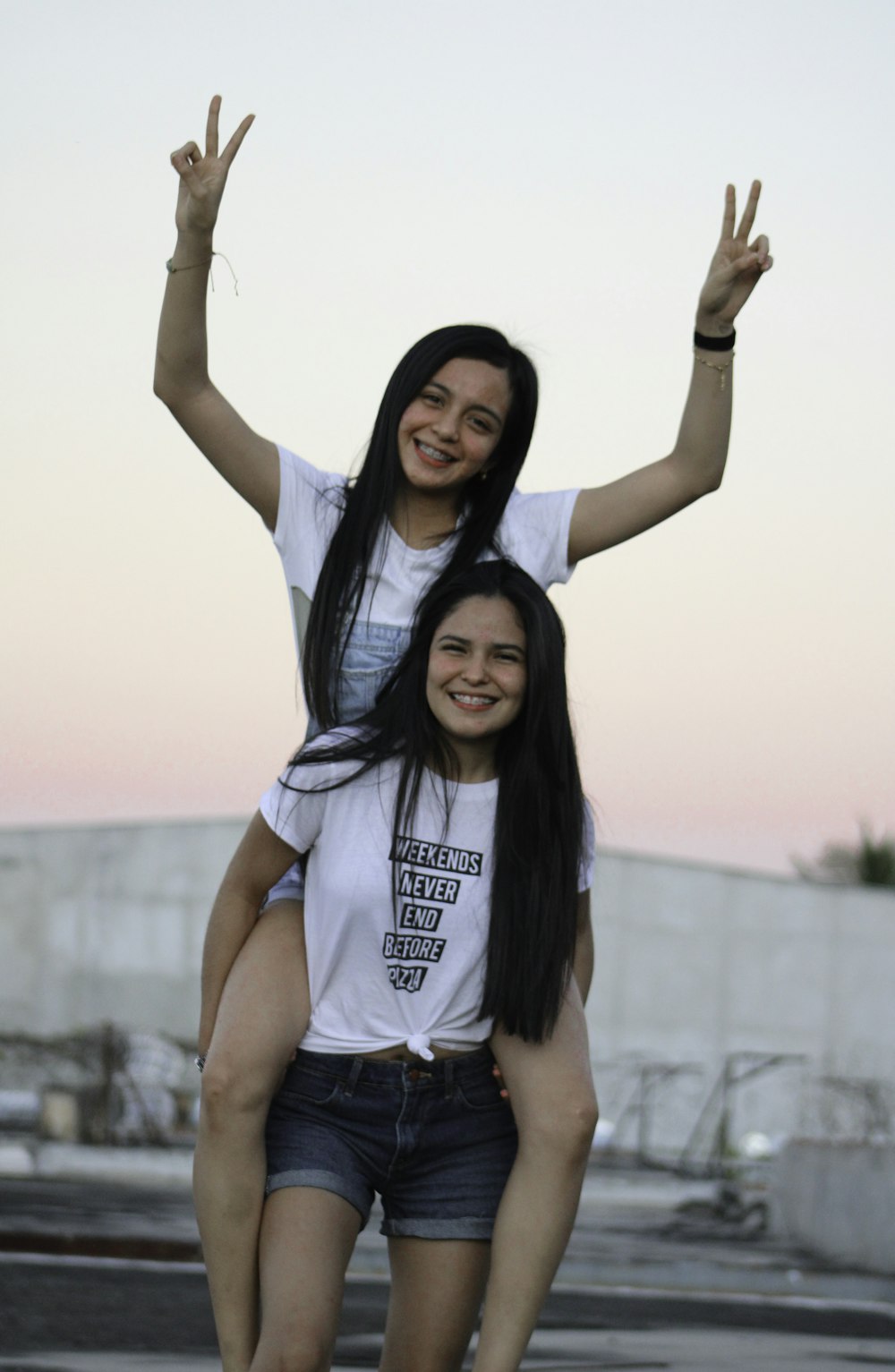 woman in white t-shirt and blue denim shorts smiling