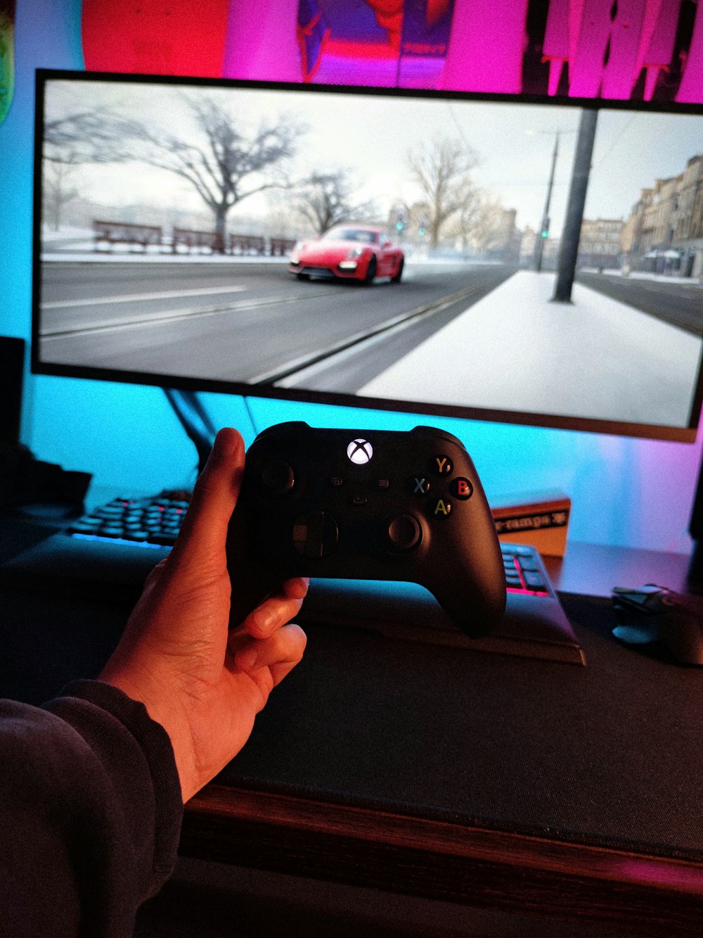 person holding black xbox one game controller