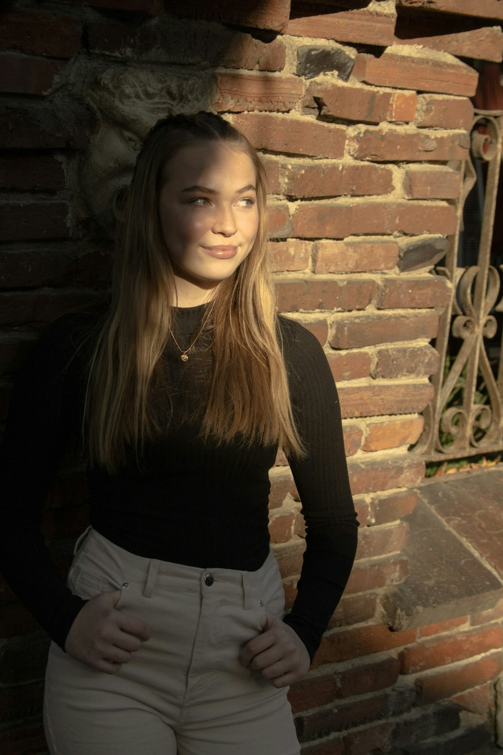 woman in black long sleeve shirt and white denim jeans