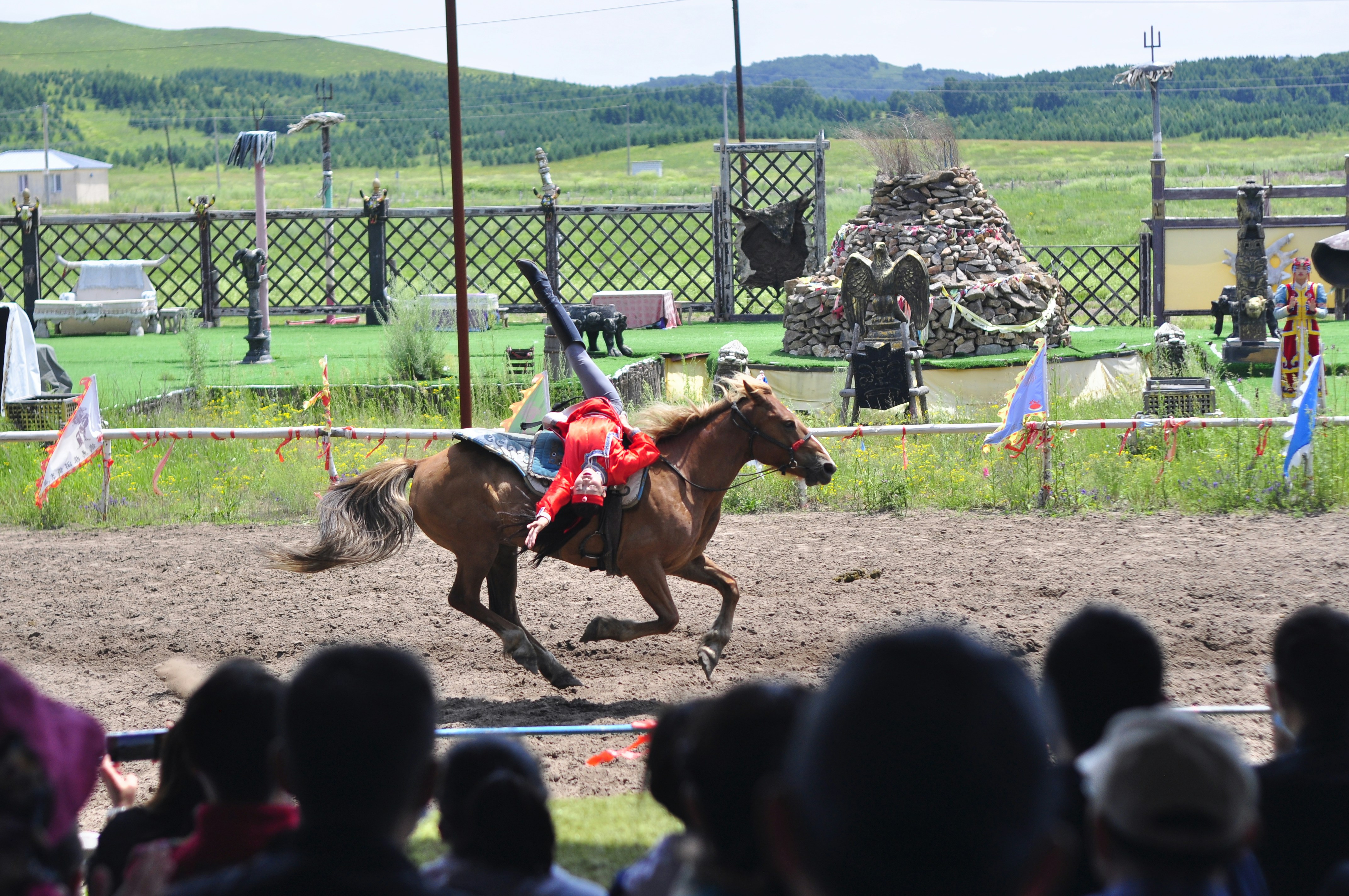 people riding horses on green grass field during daytime