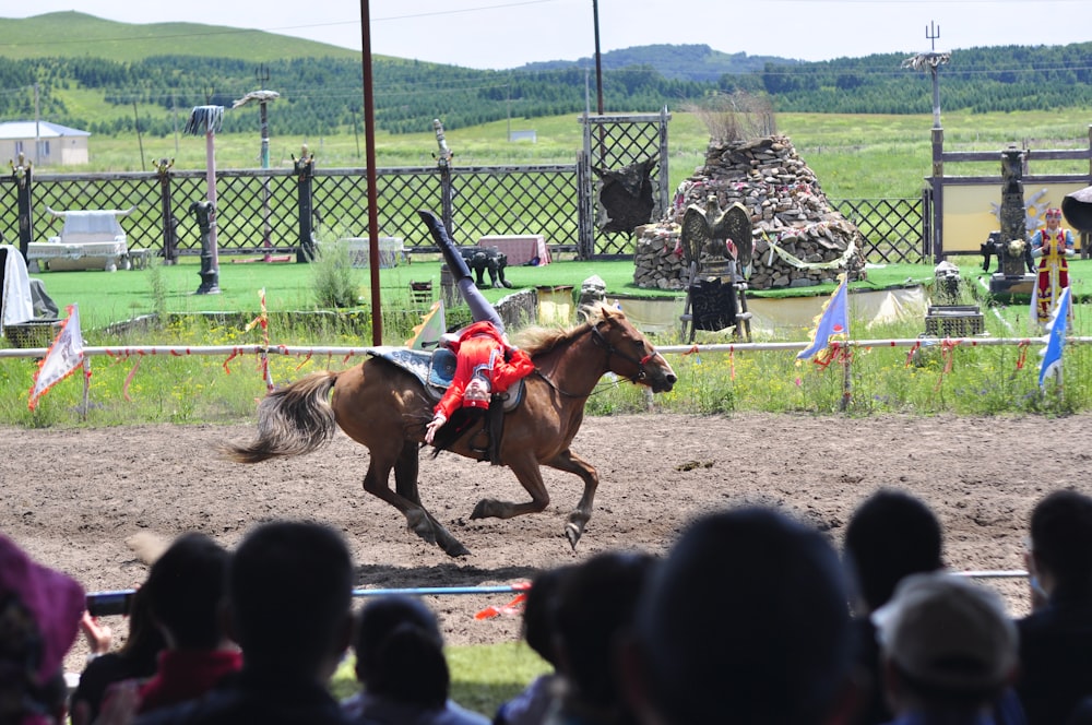 people riding horses on green grass field during daytime