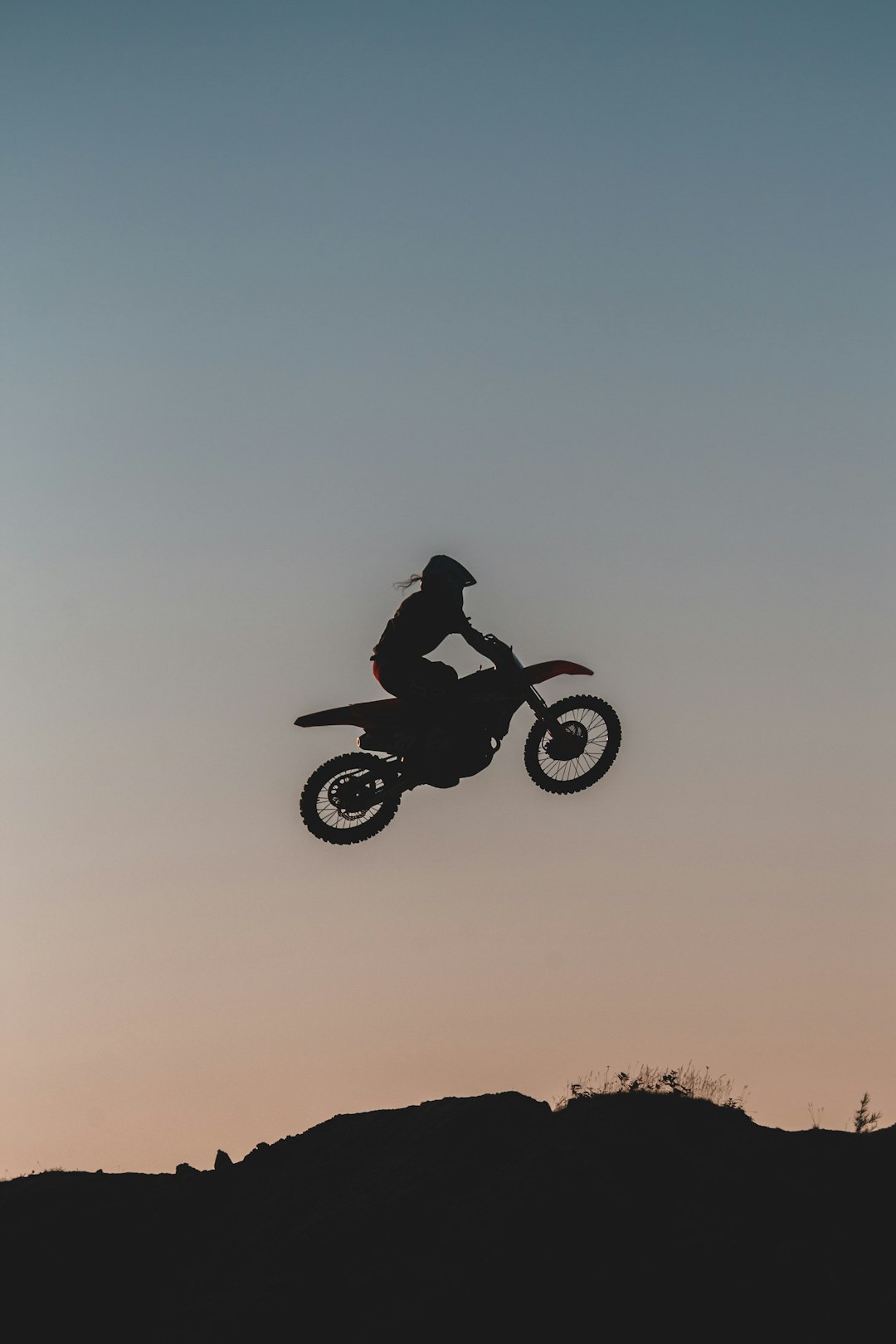 man riding motorcycle on brown grass field during daytime