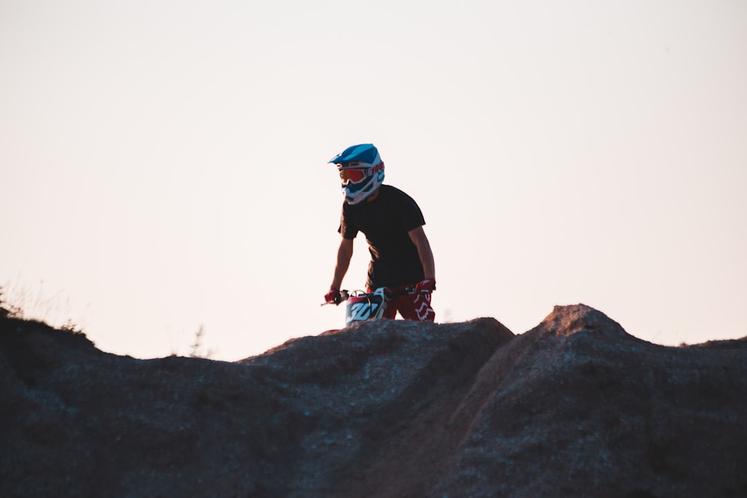 man in black jacket and blue helmet riding on white snowboard