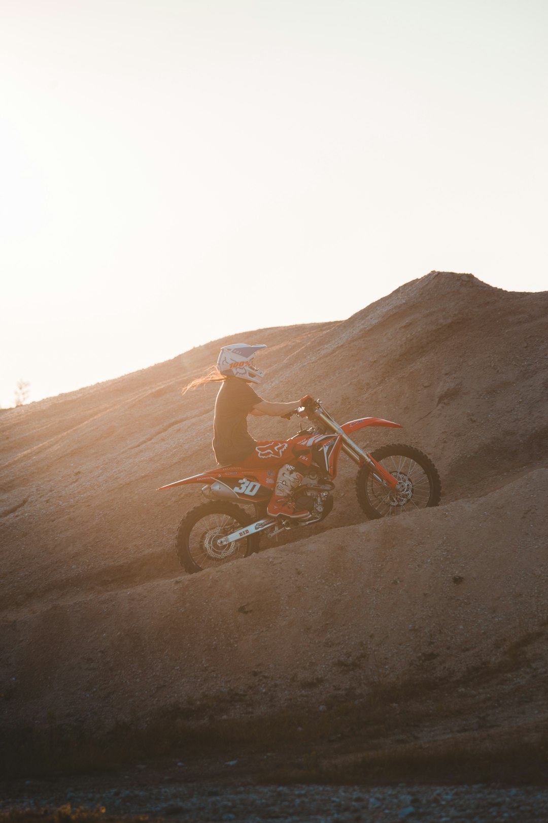 red and black motorcycle on brown sand during daytime