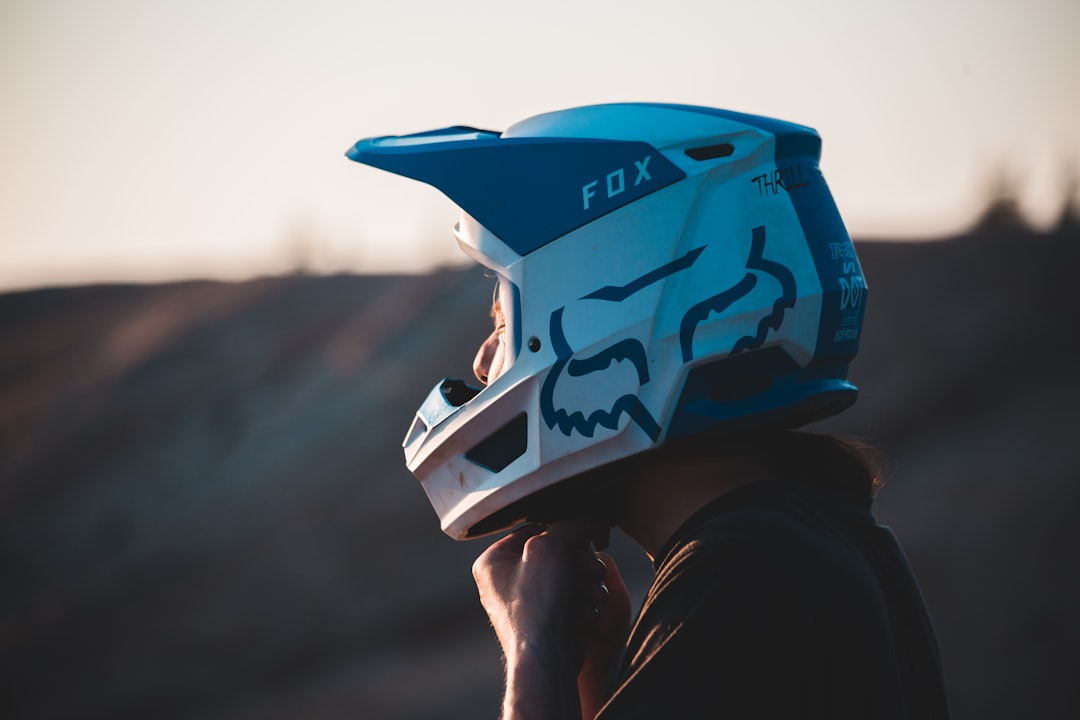 person holding blue and white helmet