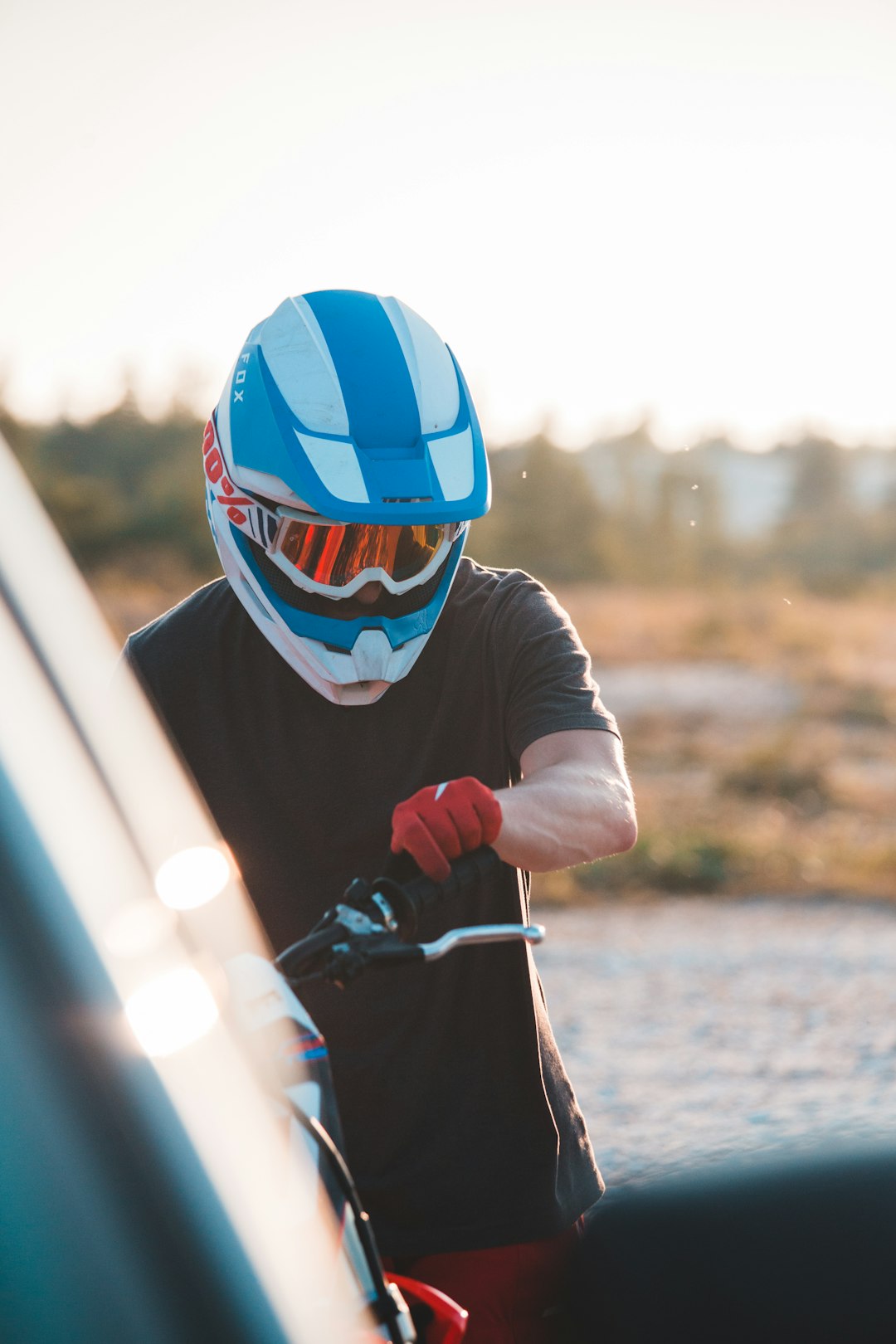 person in blue and red mask riding on bicycle during daytime
