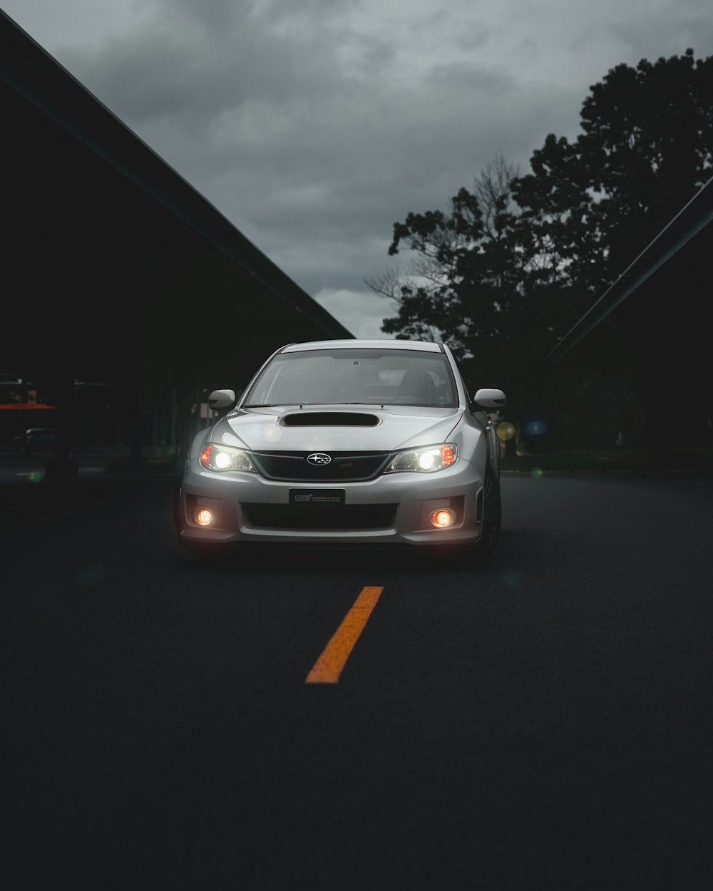 white car on parking lot during night time