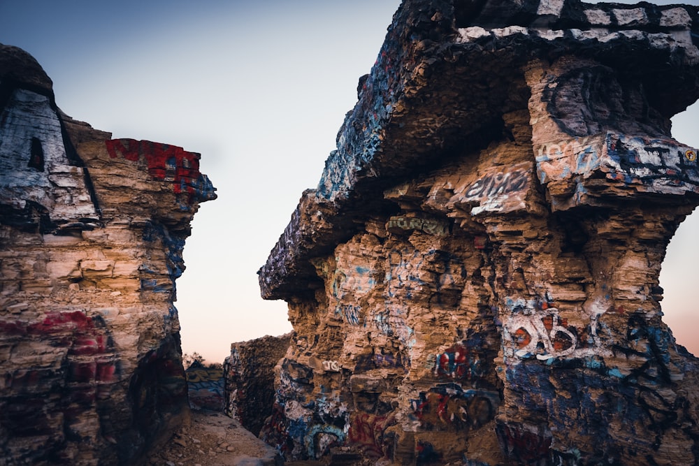 brown rock formation under gray sky