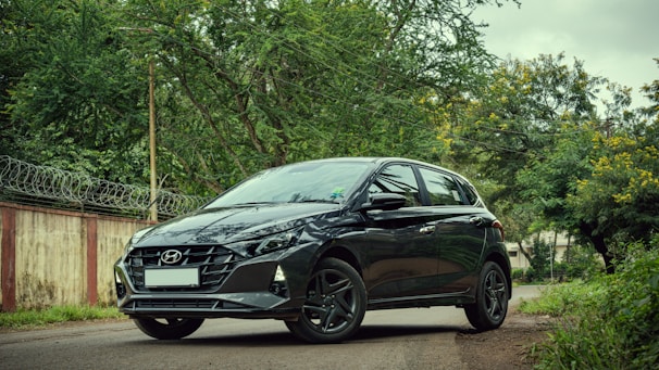 A sleek, natural car parked by a quiet street, reflecting simplicity and trust.