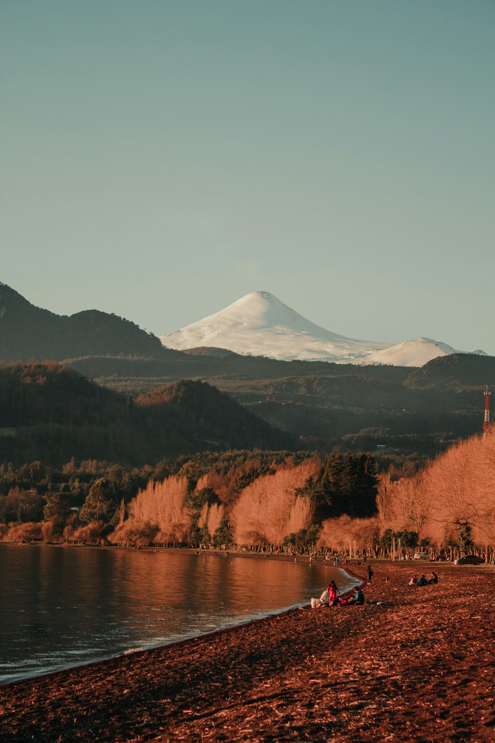 brown and green mountains near lake during daytime