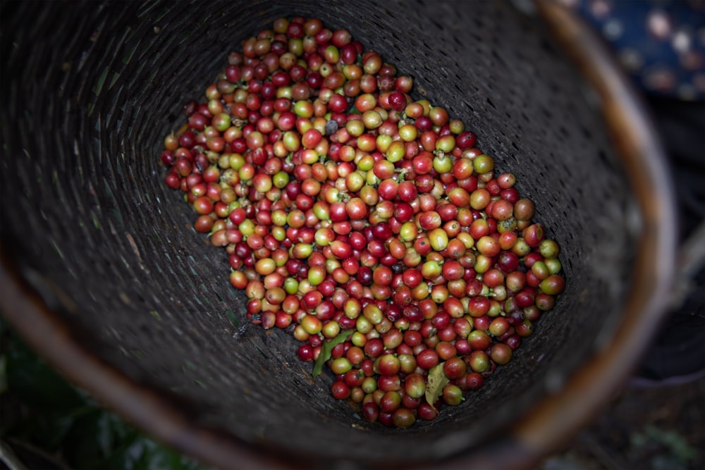 red and green round fruits in black round bowl