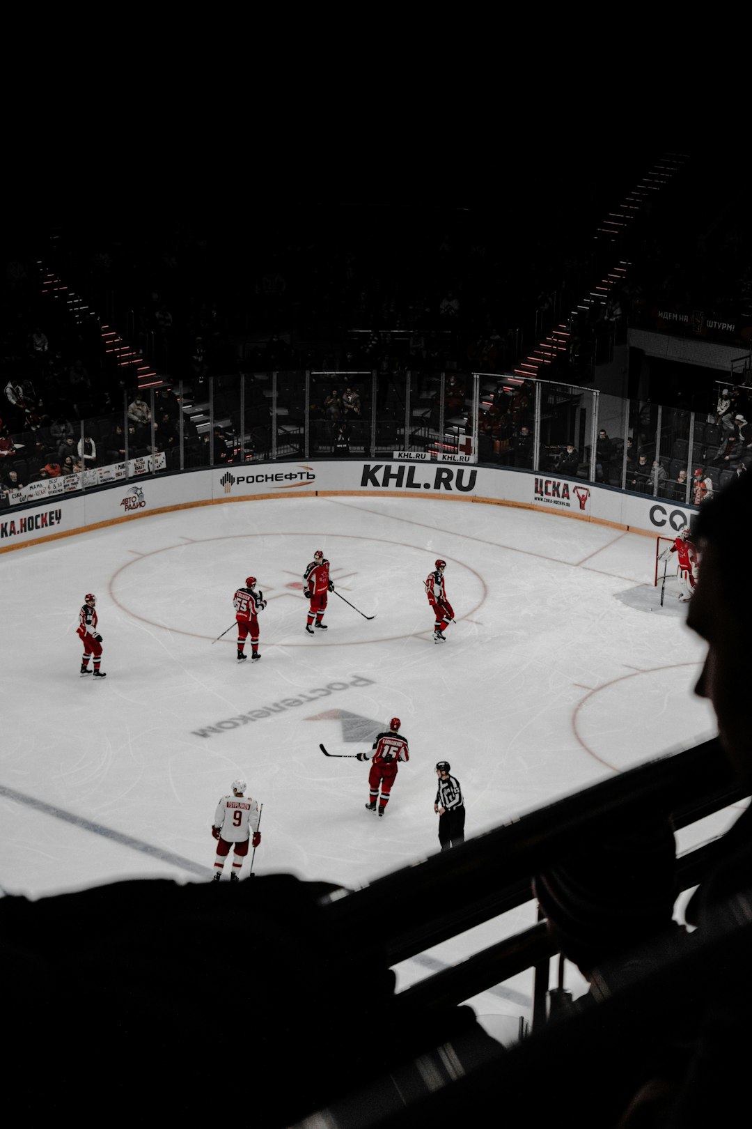 people playing ice hockey during daytime