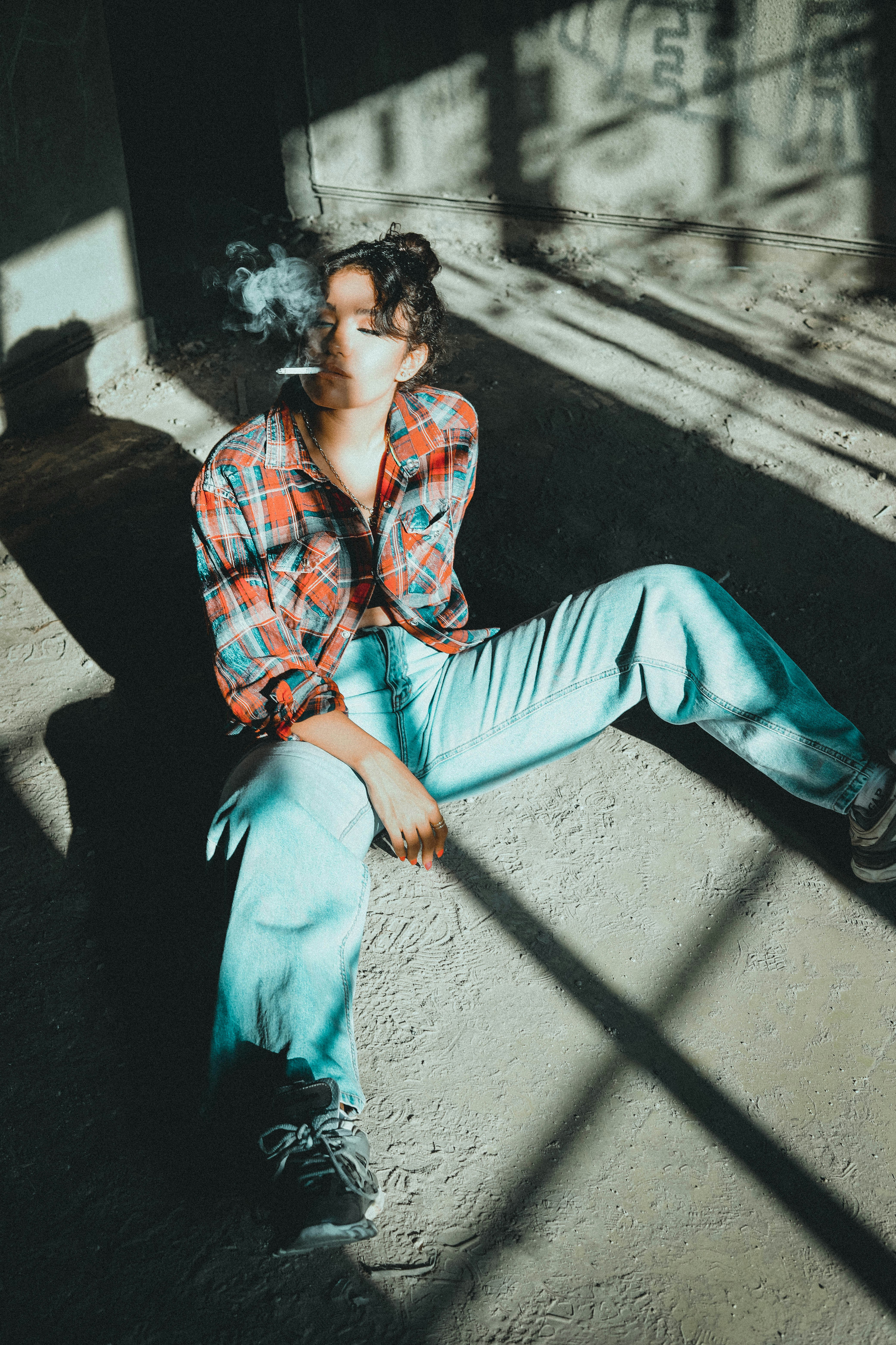 man in blue pants sitting on concrete bench