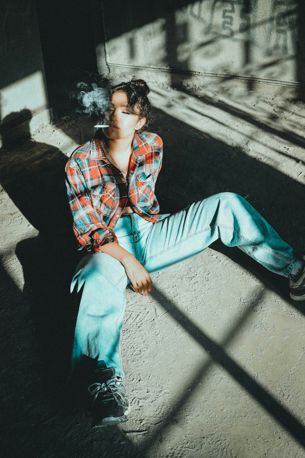 man in blue pants sitting on concrete bench