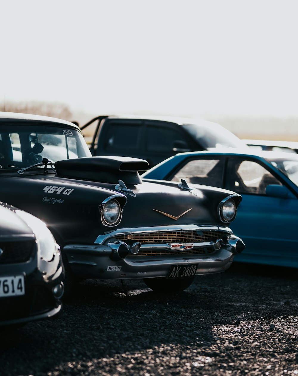 black and blue classic car on gray sand during daytime