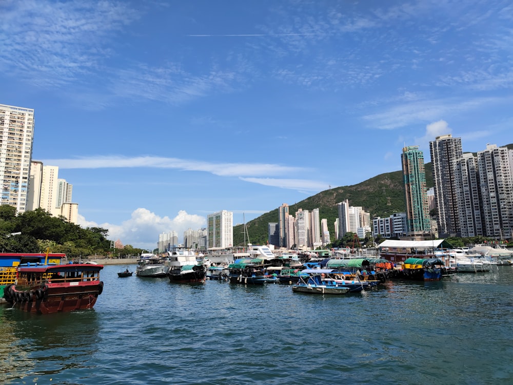 red and white boat on body of water near city buildings during daytime