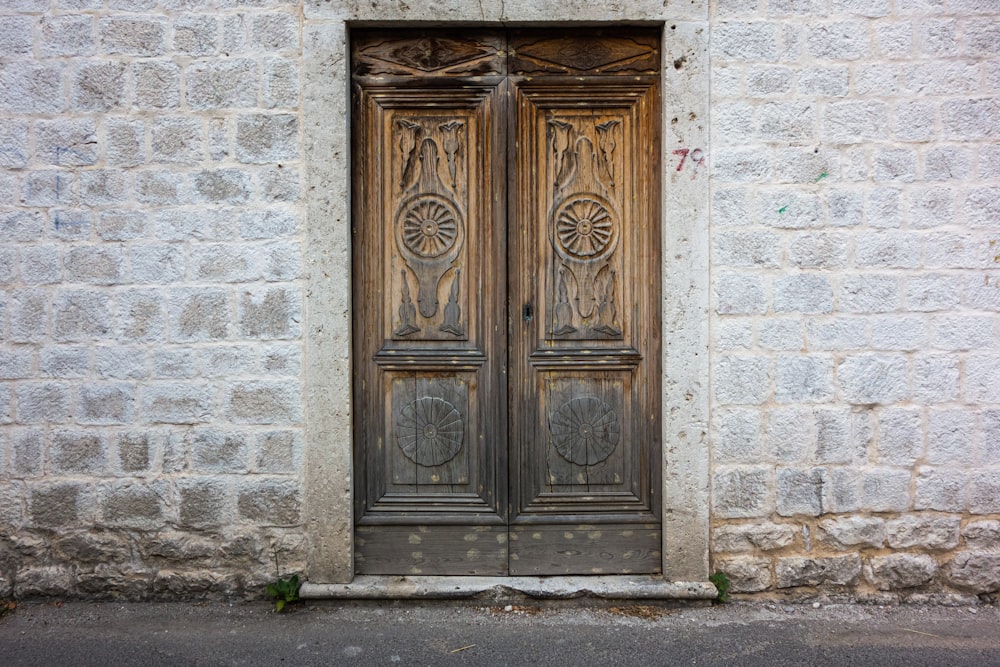 brown wooden door on gray concrete wall