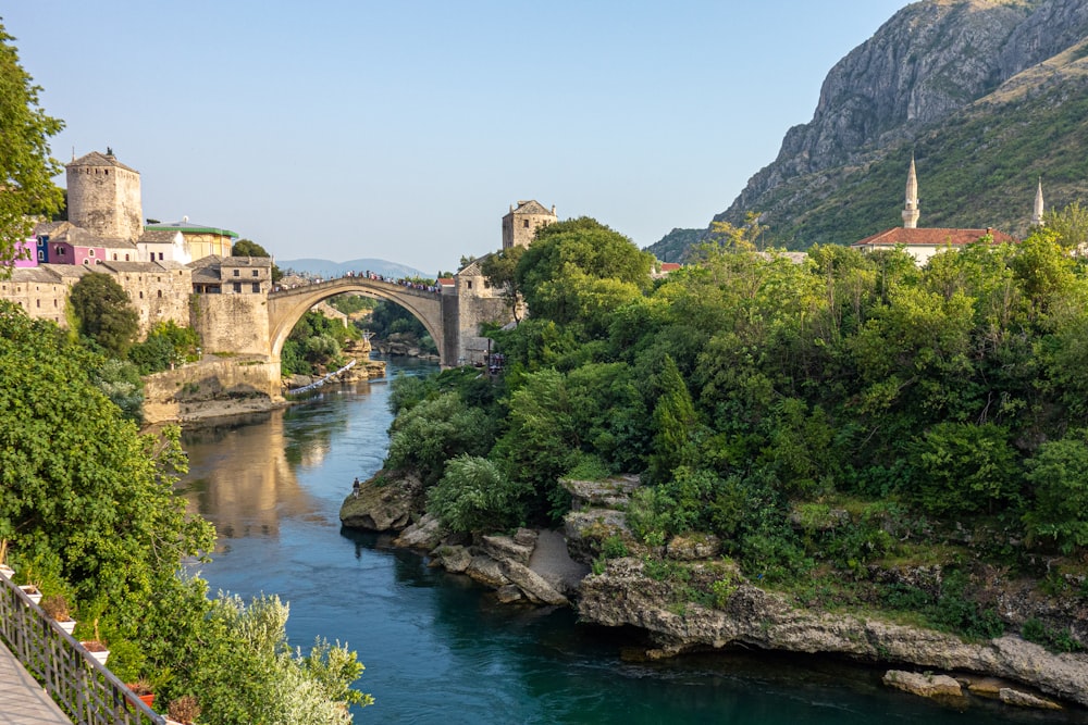 brown concrete bridge over river during daytime