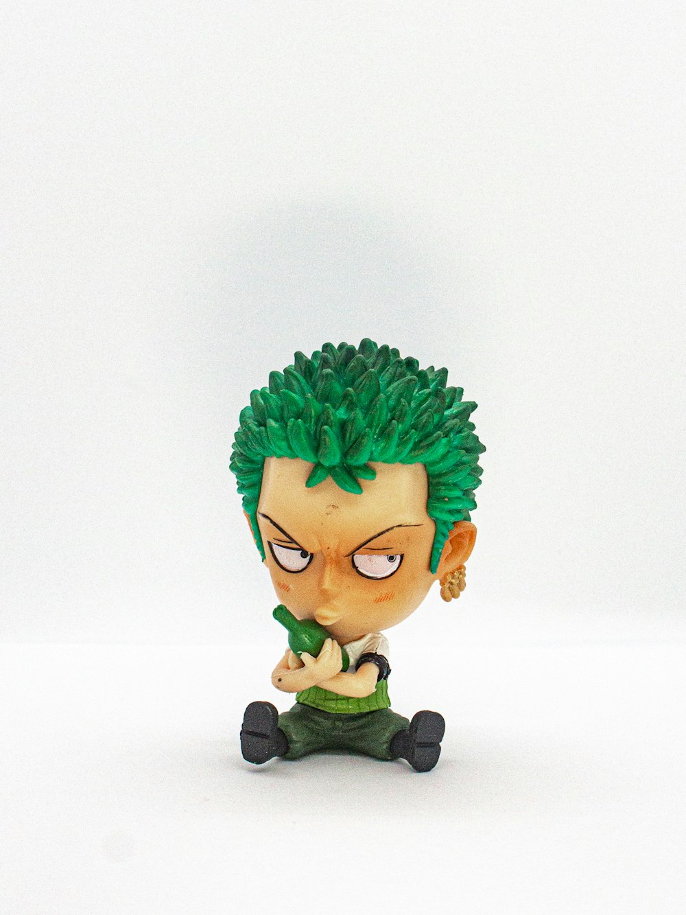 green haired boy in black and white suit figurine