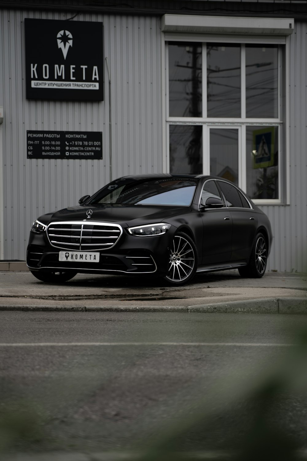 black mercedes benz coupe parked near white building