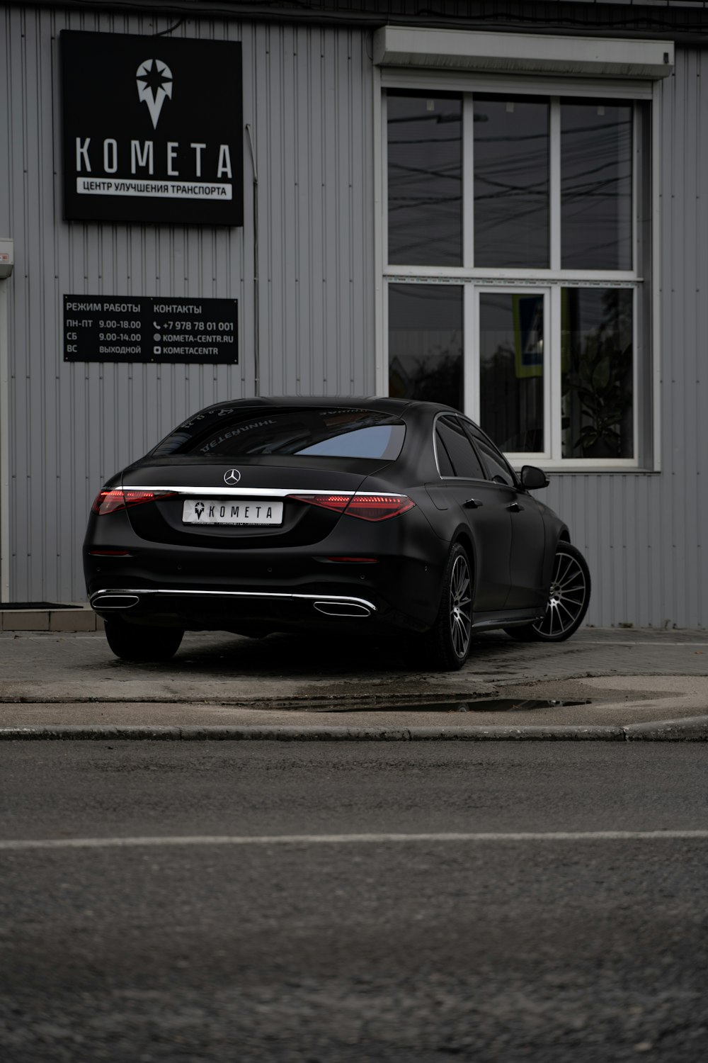 black porsche 911 parked near white building