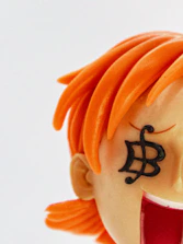 A close-up of a finely detailed 3D printed figurine of a cosplayer in vibrant costume.