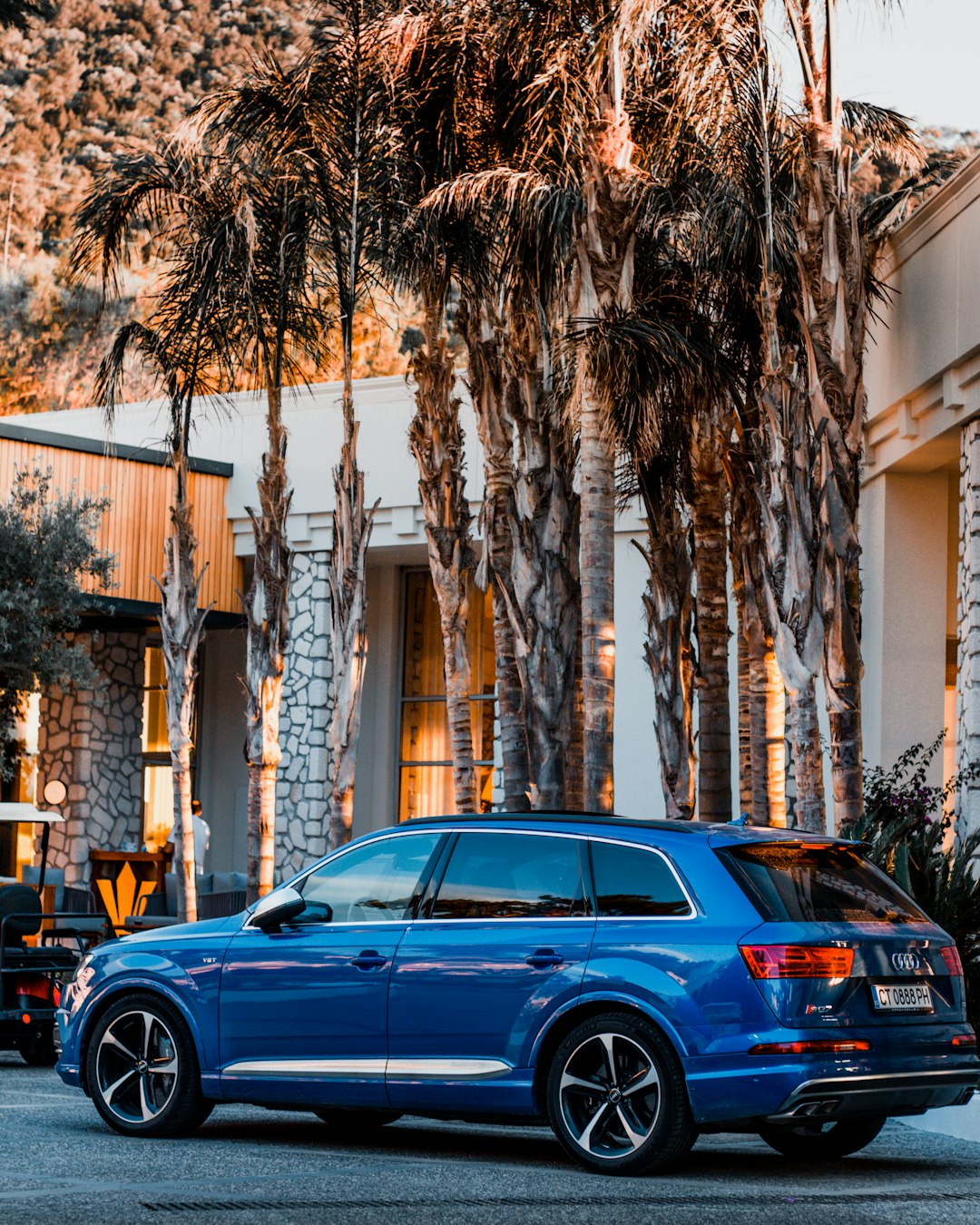 blue sedan parked near building during daytime