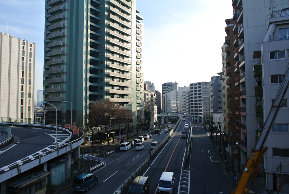 cars on road near high rise buildings during daytime