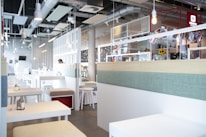 Bright and airy café interior with minimalist design and pastel accents reflecting freshness.