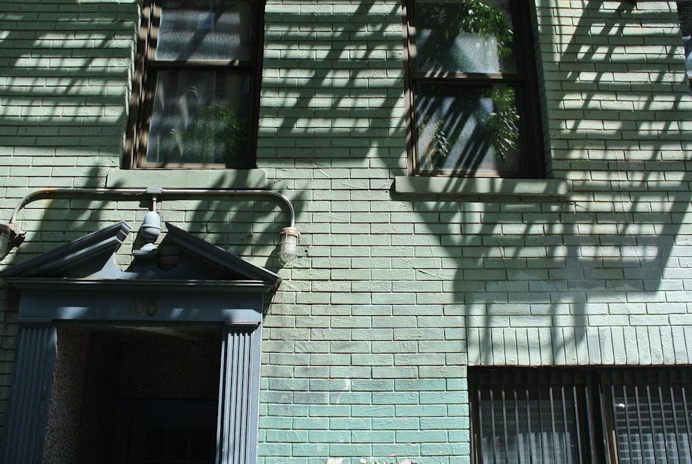 black and white outdoor lantern on gray brick wall