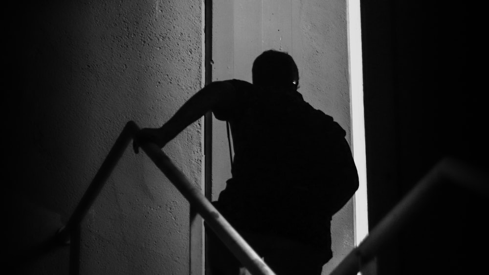 man in black t-shirt standing on staircase