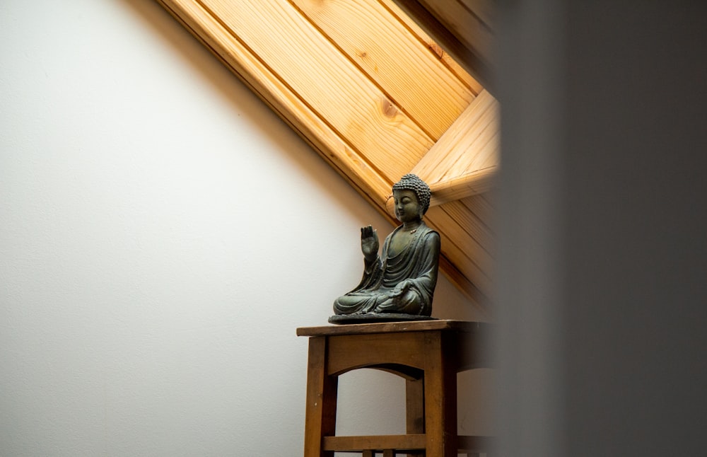 gray ceramic figurine on brown wooden table