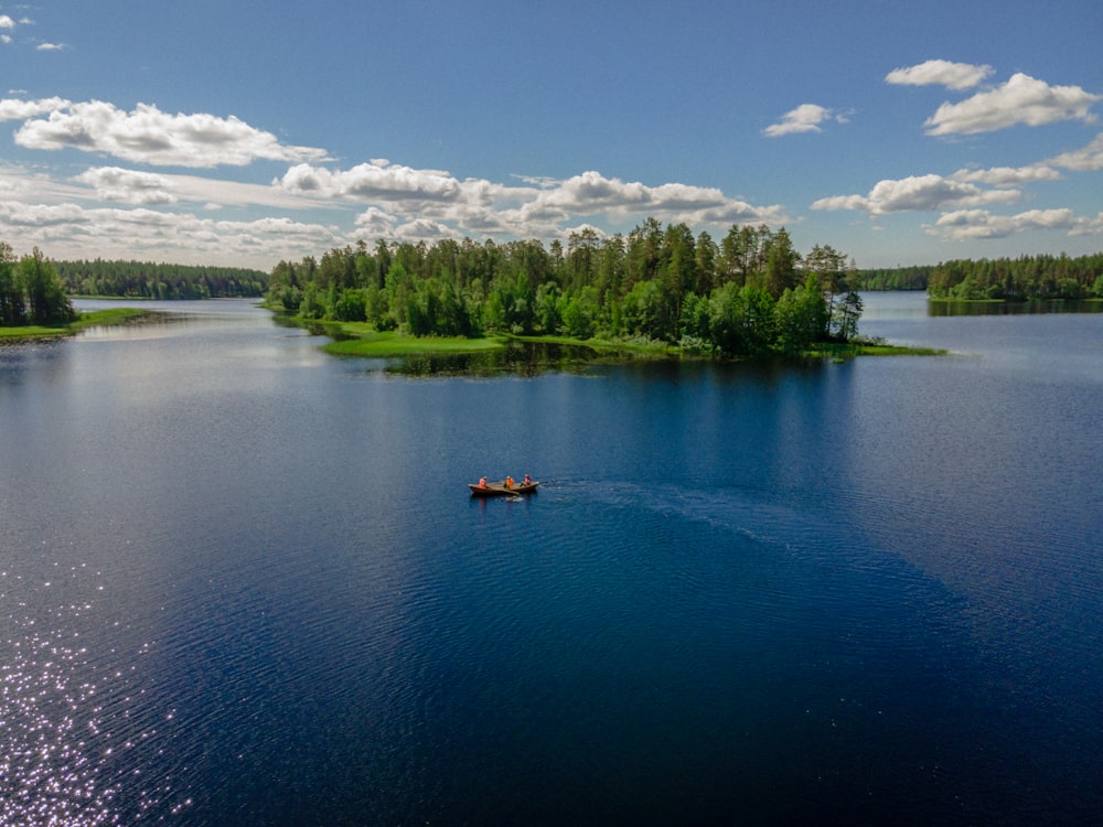 person riding on kayak on lake during daytime